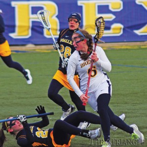 Junior midfielder Amanda Norcini runs past a La Salle University defender as she rushes up the field in the Dragons’ 12-6 victory over the Explorers Feb. 20 at Vidas Field. Norcini contributed two goals on two shots and one ground ball.