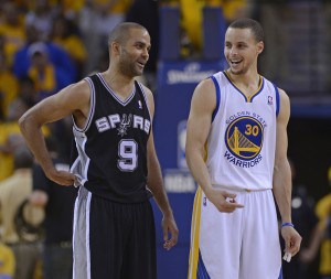 Golden State Warriors’ Stephen Curry chats with San Antonio Spurs’ Tony Parker at the start of overtime in Game 4 of the NBA Western Conference playoffs at Oracle Arena in Oakland, Calif., May 12.