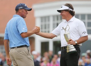 Caddie Jim Mackay congratulates Phil Mickelson on winning the Open Championship at Muirfield in Gullane, Scotland, July 21. With the win, Mickelson clinched his fifth career major championship on the PGA Tour.