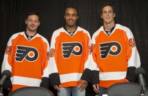 From left, recently acquired Mark Streit, Ray Emery, and Vincent Lecavalier don their new Philadelphia Flyers sweaters during a news conference in the Hall of Fame room at the Wells Fargo Center in Philadelphia July 9.