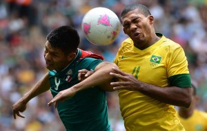 Mexico’s Oribe Peralta, left, and Brazil’s Juan Jesus battle for the ball in the gold medal match at the Summer Olympics August 11, 2012, at Wembley Stadium in London. Mexico topped Brazil by a score of 2-1, as Peralta scored twice.