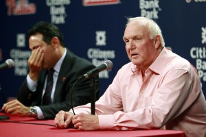 Charlie Manuel speaks with the media Aug. 16 after being fired as manager of the Philadelphia Phillies by the team’s general manager, Ruben Amaro Jr., left, who wipes away tears. Ryne Sandberg has taken over for Manuel on an interim basis.