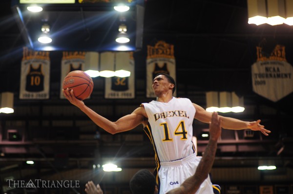 Junior shooting guard Damion Lee skies for a layup during a game at the DAC. (Ken Chaney - The Triangle)