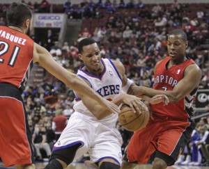 Philadelphia 76ers forward Evan Turner drives between the Toronto Raptors guards Greivis Vasquez and Kyle Lowry during the third quarter at the Wells Fargo Center in Philadelphia Jan. 24. Turner scored 13 points as the Raptors beat the Sixers 104-95.