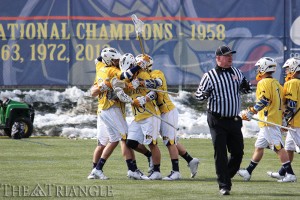 The men’s lacrosse team celebrates scoring a goal against Robert Morris University March 1. The Dragons won that game, 18-12, and have won seven of their last nine since that afternoon to clinch the No. 2 seed in the Colonial Athletic Association tournament. The team concludes the regular season April 25 at High Point University.