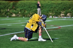 Senior attacker Nick Trizano kneels down at the end of the Drexel men’s lacrosse game versus Denver University in the quarterfinals of the NCAA Tournament. The Dragons lost, 15-6, to the Pioneers in what would prove to be Trizano’s final game of his collegiate career. (Ken Chaney - The Triangle)