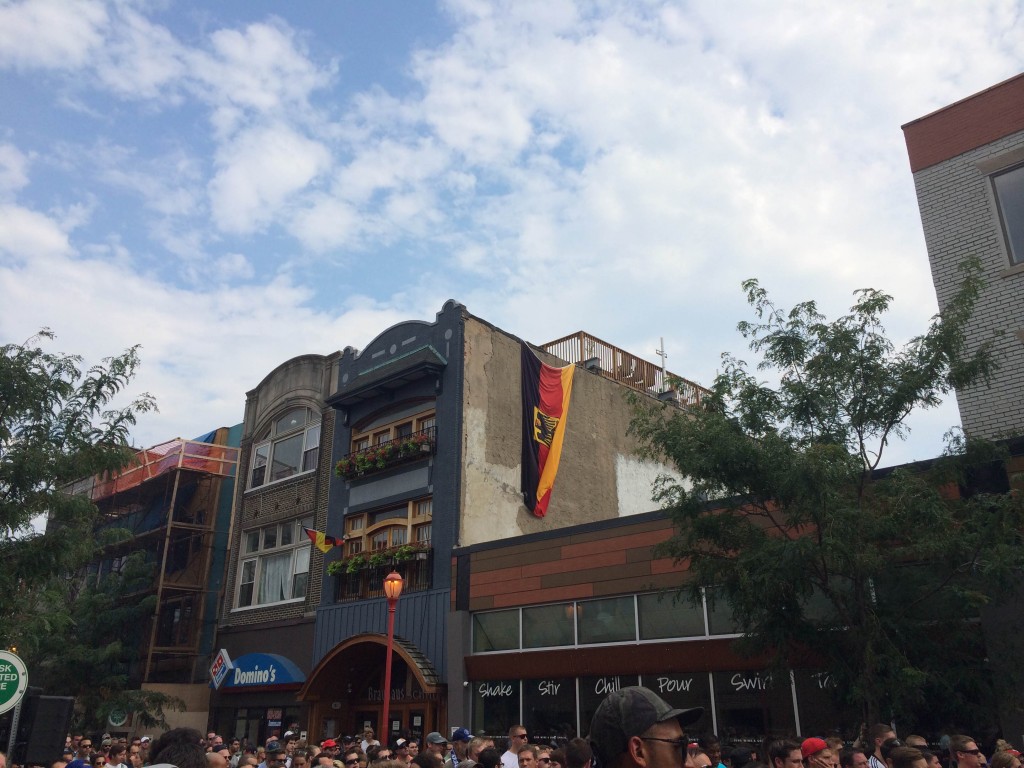 A German flag hangs from the side of Brauhaus Schmitz during the World Cup final Sunday.