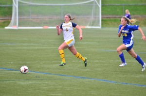 Sophomore defender Abbey Romano fights for the ball against the University of Delaware during an Oct. 4. That game was the last time the Dragons were held scoreless. (Ken Chaney - The Triangle)