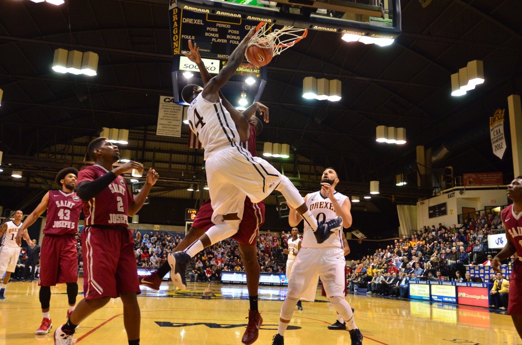 Rodney Williams dunks over a Saint Joseph's University defender during their Nov. 17 contest. (Ken Chaney - The Triangle)