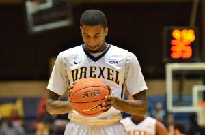 Junior guard Tavon Allen looks at the ball before shooting a free throw Nov. 30. (Ken Chaney - The Triangle)