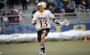 Ryan Belka runs through the snow during an early season matchup for the men’s lacrosse team. This week, Belka was a big part of a winning effort for the team, scoring 4 goals and 2 assists as the Dragons defeated Bryant University 11-8. (Photo Courtesy - Drexeldragons.com)